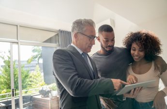 Landlord reviewing rental criteria checklist and asking questions to potential tenants